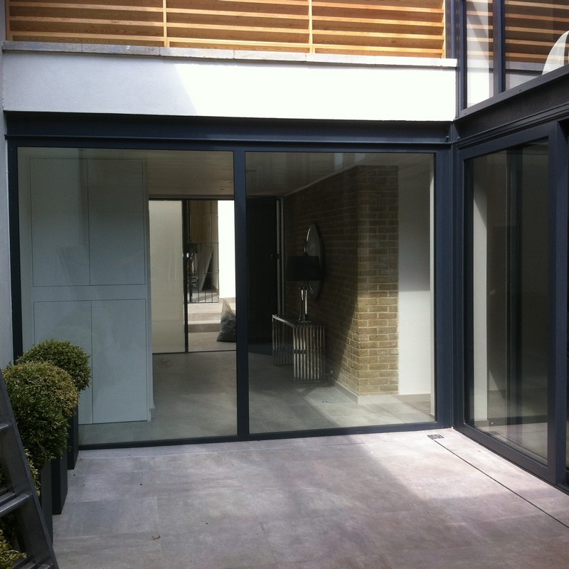 Floor-to-ceiling sliding doors opening to courtyard in Richmond