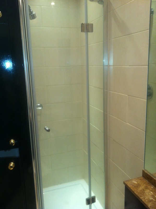 Frameless glass shower enclosure with chrome fittings in Richmond