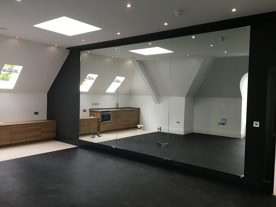 Frameless glass wall dividing loft conversion in Richmond